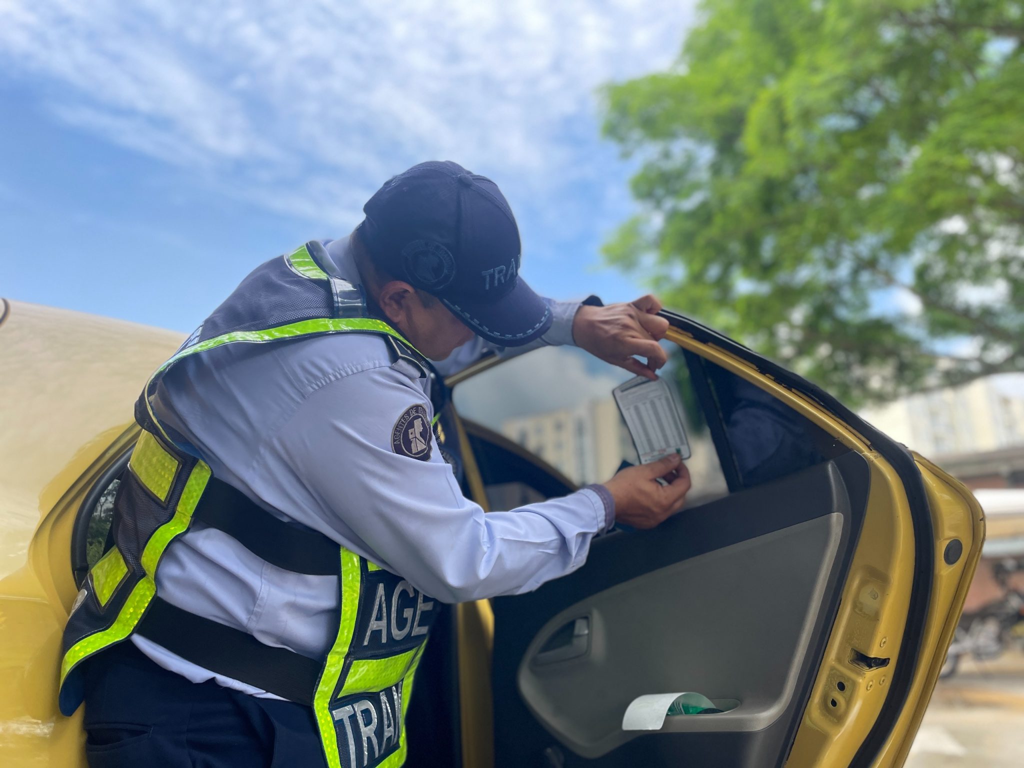 agente de tránsito pega tarifa de taxímetros