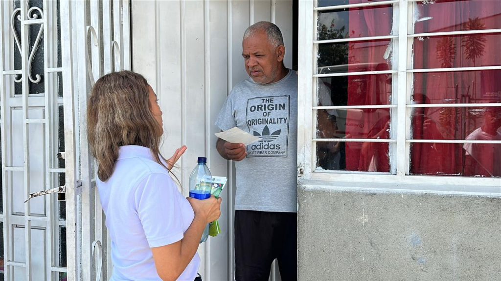 funcionaria visita casa con volante de matriculas